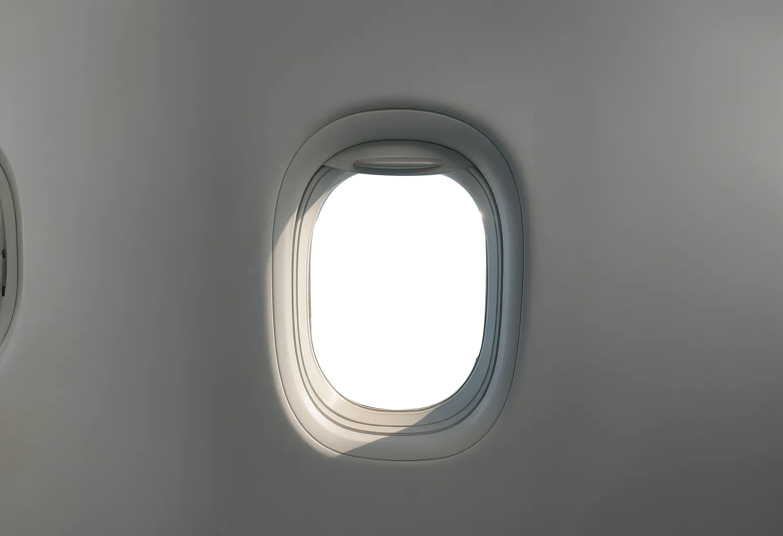 飛行機の窓から外を見る旅行者